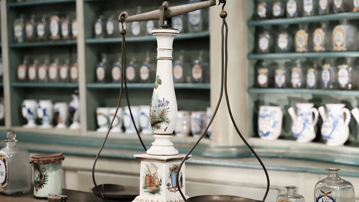 Apothecary scales and labelled jars on shelves