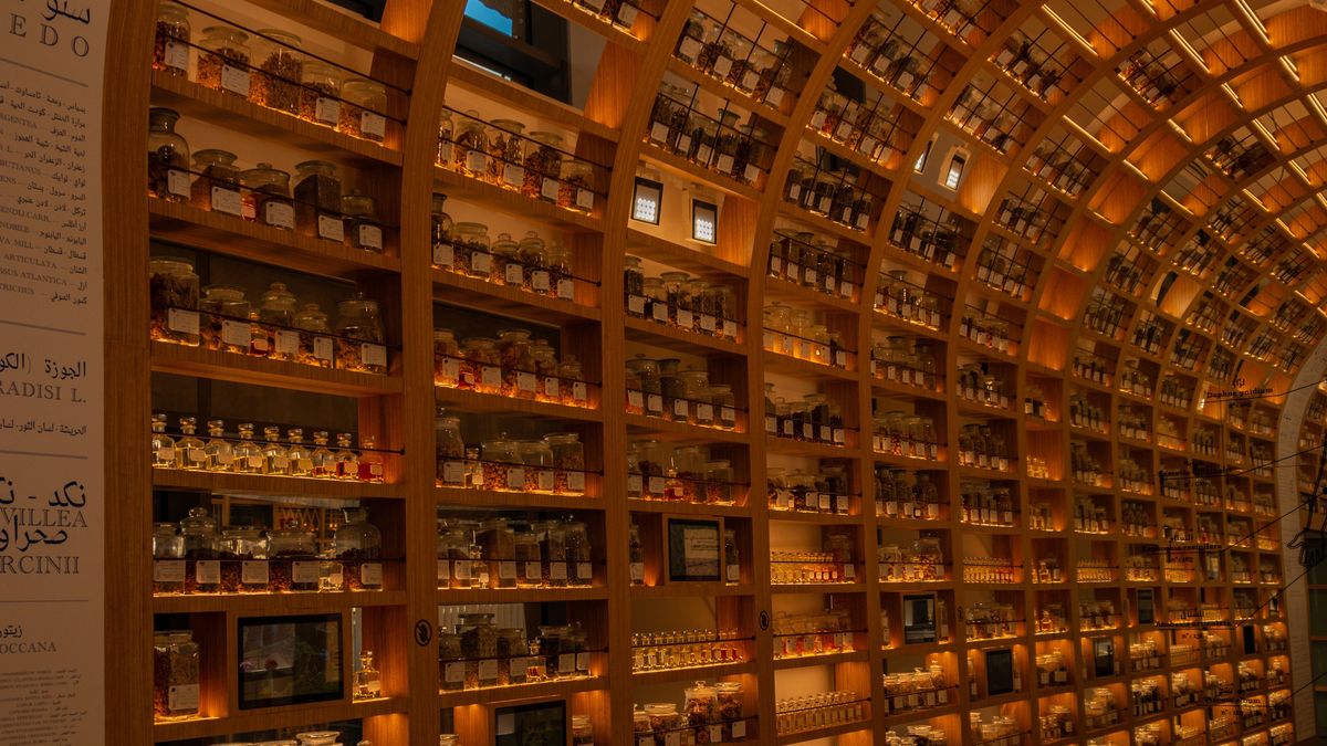A wall of amber apothecary drawers and bottles