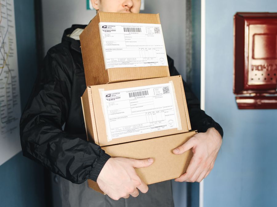 A person carrying labelled parcels ready for dispatch